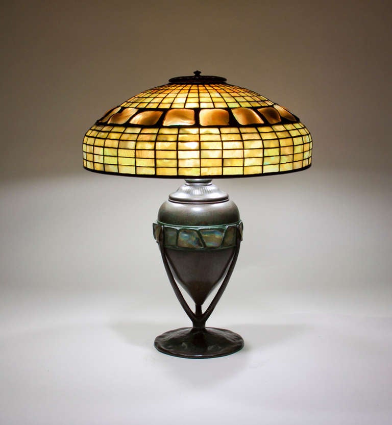 A Tiffany Studios leaded glass and bronze table lamp comprising a 