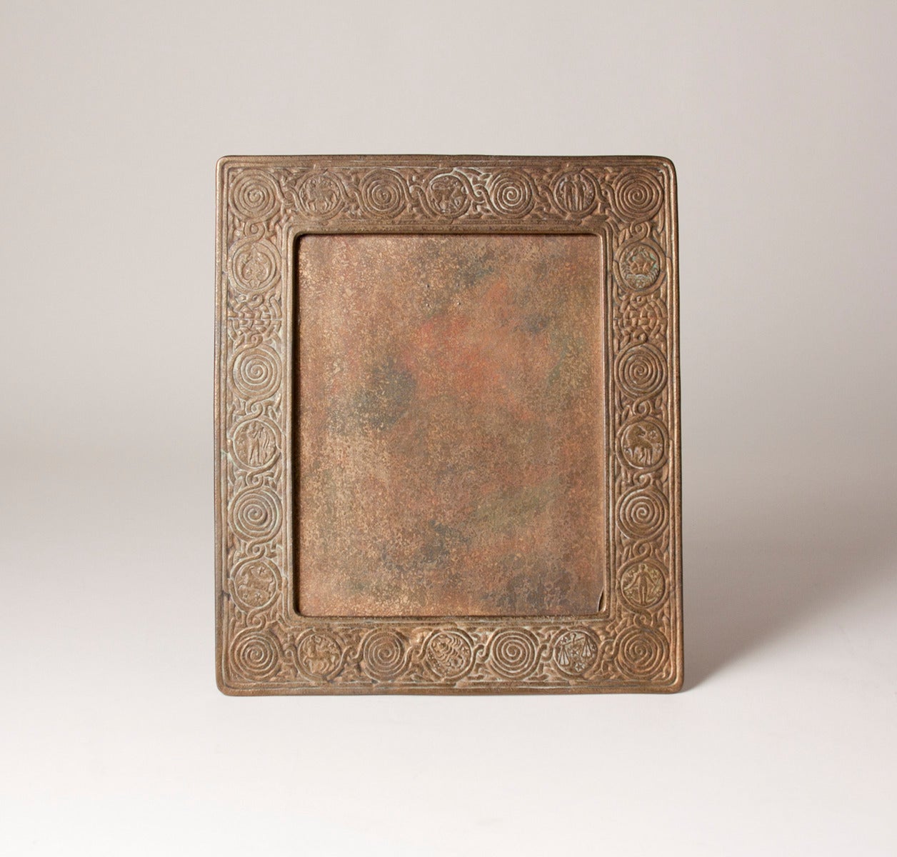 A Tiffany Studios 'Zodiac' Picture frame in original gold doré finish with traces of the original polychrome.   The frame will display an 8x10