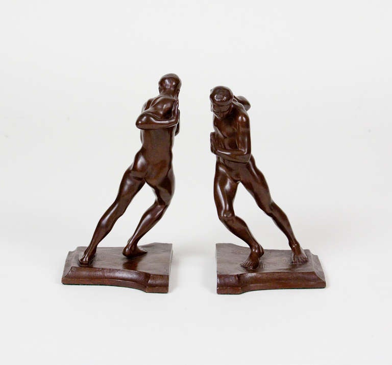 A pair of bronze bookends by American sculptor Harriet W. Frishmuth in rich brown patina, each figure with inscribed signature and stamped foundry marks.