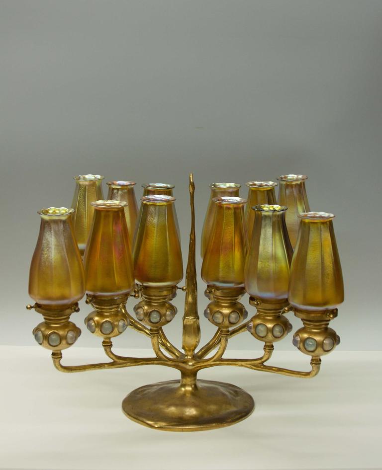 A rare and exceptional Tiffany Studios 12-light bronze and turtleback jewel candelabrum with 12 gold iridescent favrile glass shades, signed.  