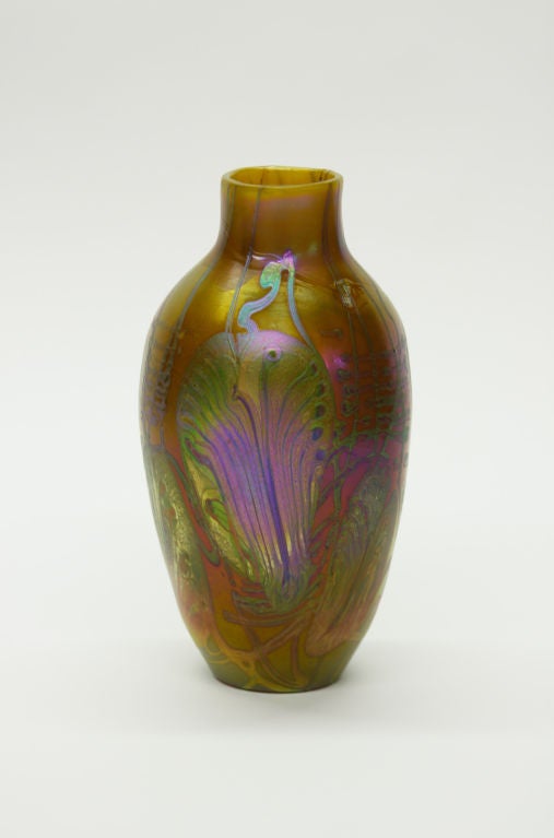 An early and rare Tiffany Studios decorated favrile glass vase, pumpkin background with iridescent purple, green and gold leaf and vine design. A similar example is illustrated in Joppein, Louis C. Tiffany Meisterwerke des amerikanischen