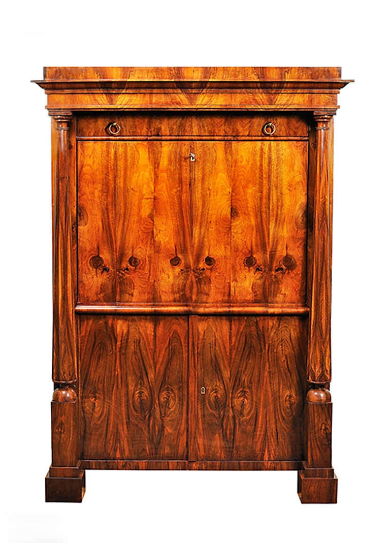 A Biedermeier secre´taire with bookmatched walnut veneer with drop-down door to form writing area with book-matched maple surface, revealing a series of drawers finished in original faux marble paint.

Vienna, circa 1825-1830.