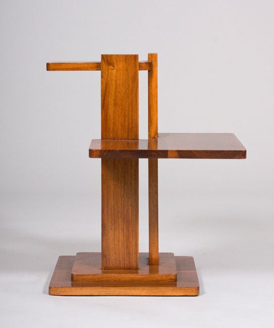 A modernist side table in French walnut with two tiers.