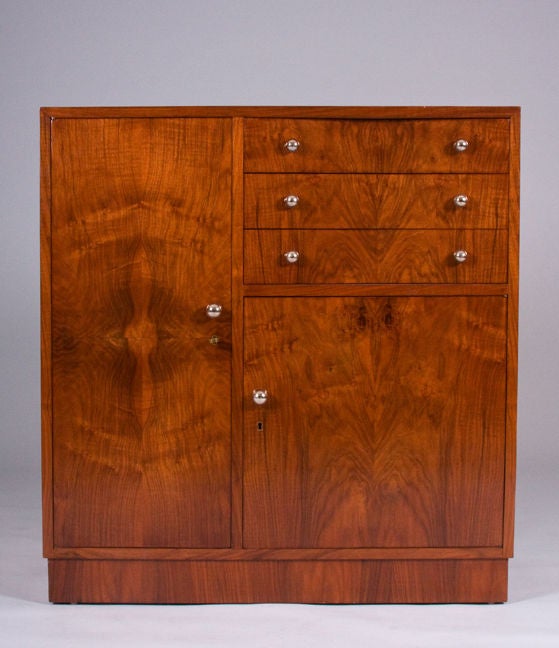 A Modernist cabinet attributed to Louis Sognot.

Walnut veneer with nickeled bronze pulls,

France, circa 1930.

Measures: 41.0" H x 39.3" W x 17.7" D.