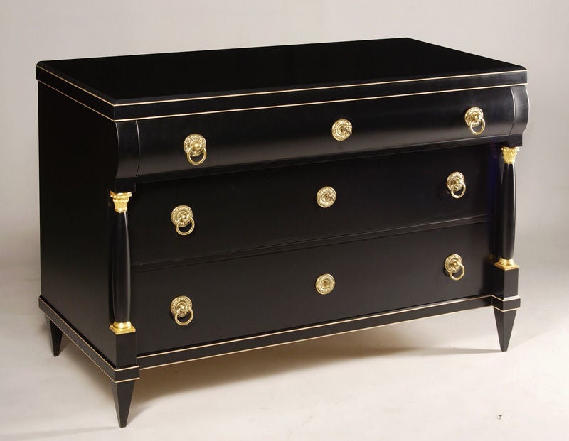 A pair of Biedermeier-style commodes.
Ebonized pear wood veneer with hand-carved 23-karat gilt details combination of hand rubbed shellac and varnish finish.