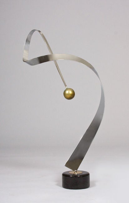 DO 21786.

An abstract Futurist sculpture by Curtis Jere.

In chrome with gilt details with marble base.

American, circa 1960-1965.