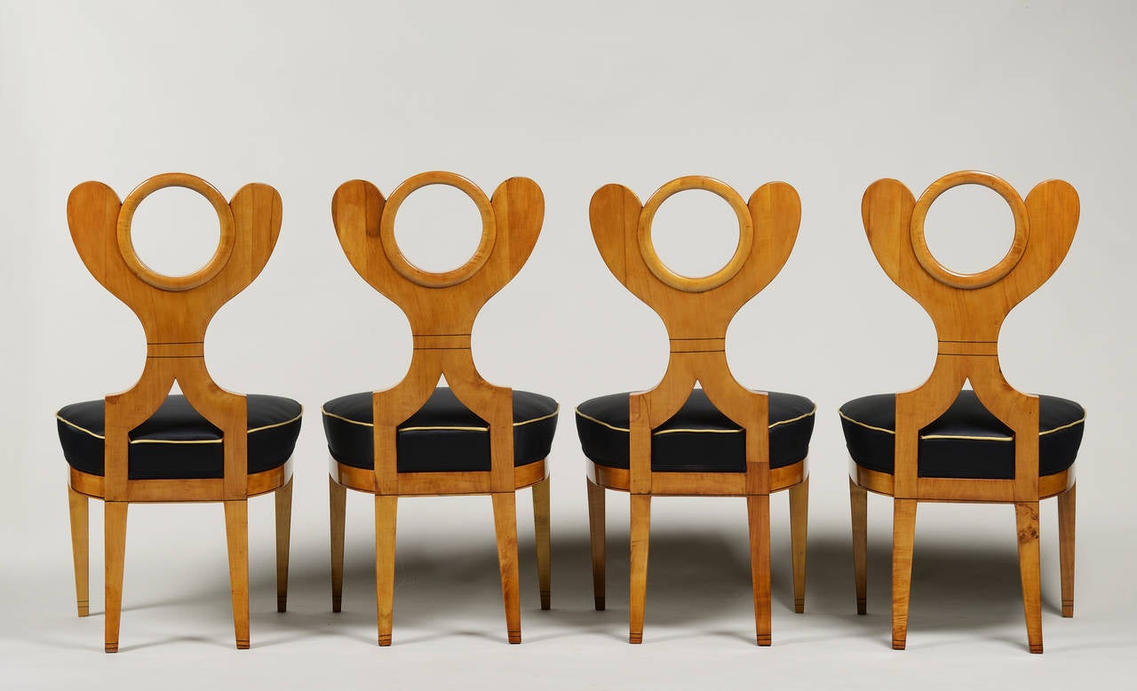 An iconic suite of four Danhauser designed chairs in solid maple with ebonized detailing.