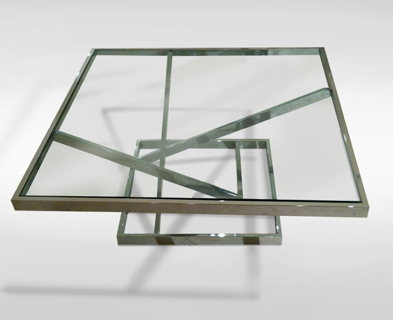 A modernist coffee table chrome with deep beveled glass top.