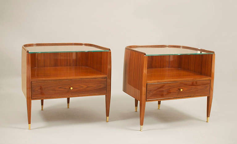 Book matched rosewood veneer with vertically convex sides, single drawer, and inset glass top.  Cast brass pulls and sabots.