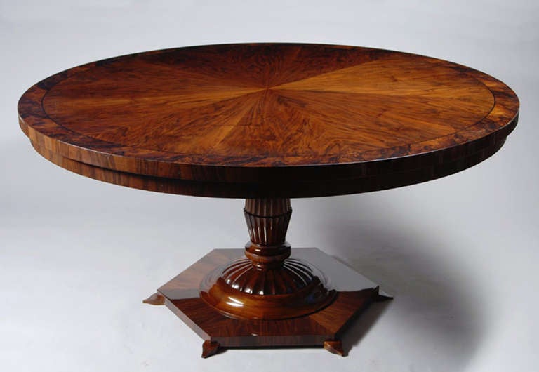 A large Biedermeier inspired pedestal table with bookmatched walnut veneer and ebonized perimeter inlays, with carved and fluted pedestal sitting atop a hexagonal base. Combination hand rubbed shellac and poly finish.
 
