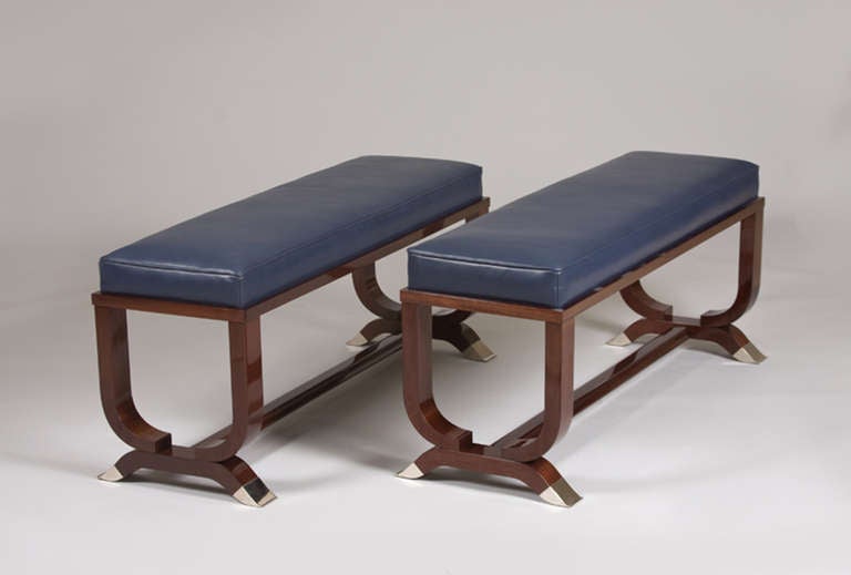 A contemporary pair of Art Deco inspired benches designed by Andrea Zemel for Iliad. Solid mahogany with nickel sabots.
 