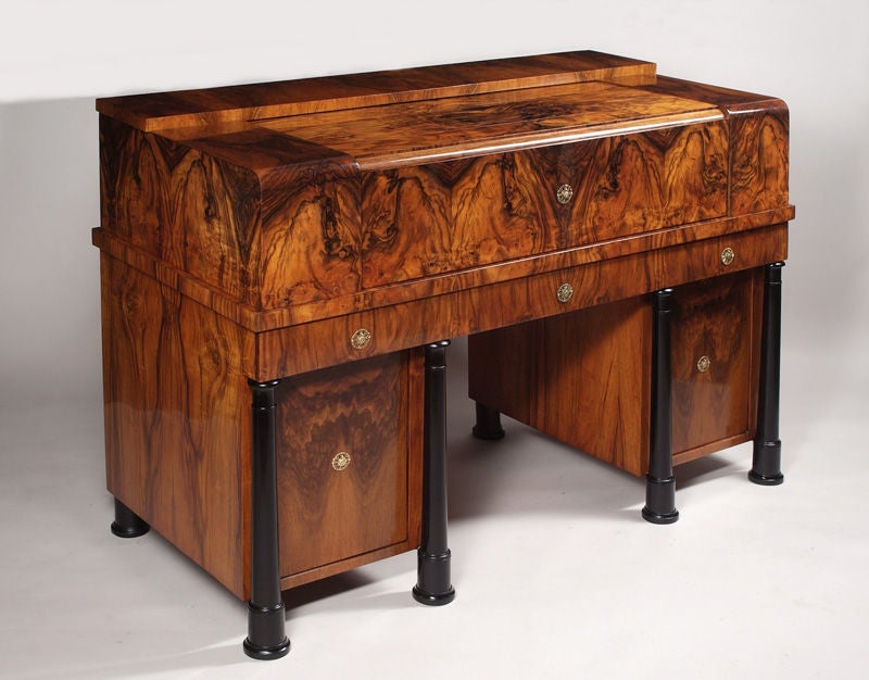 An important Biedermeier drop front gentleman's desk. Highly figured walnut veneer. Maple gallery with exquisite hand painted schwarzlot detail. Locking roll top with slide out writing panel and hidden document compartment beneath ebonized surface