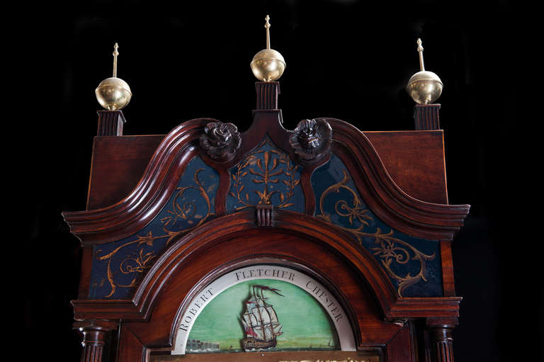 A fine quality Georgian period longcase clock with spectacular figured flame veneered mahogany case with a long trunk door, flanked by reeded quarter columns and solid mahogany capitals. The inlay panelled base with double plinth and reeded columns