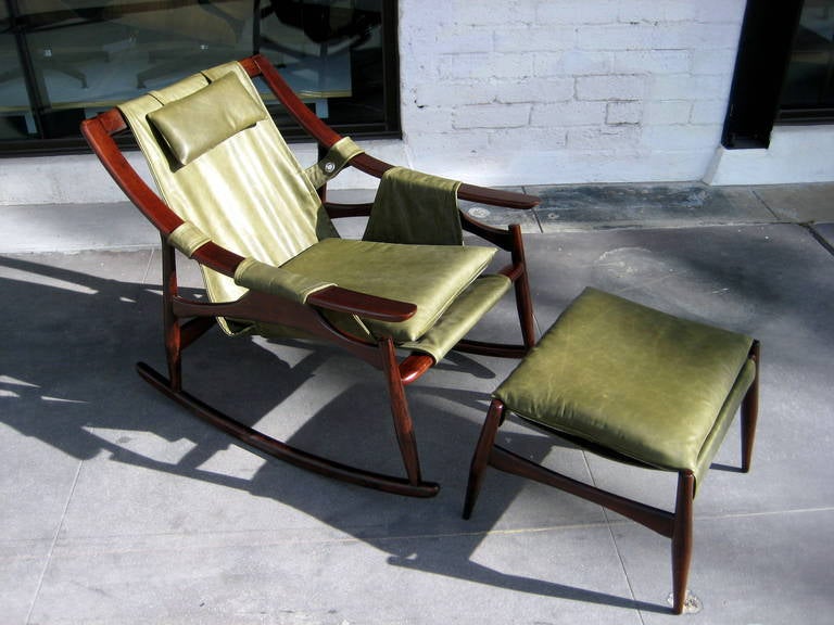 A Brazilian Mid Century Modern solid rosewood and leather rocking chair and ottoman from the 1960's. Both pieces have been reupholstered using high quality leather and conforms to the template of the original material. It is extremely rare to have