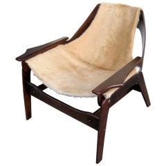 A stained walnut sling chair designed by Jerry Johnson in 1964