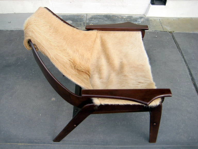 American A stained walnut sling chair designed by Jerry Johnson in 1964