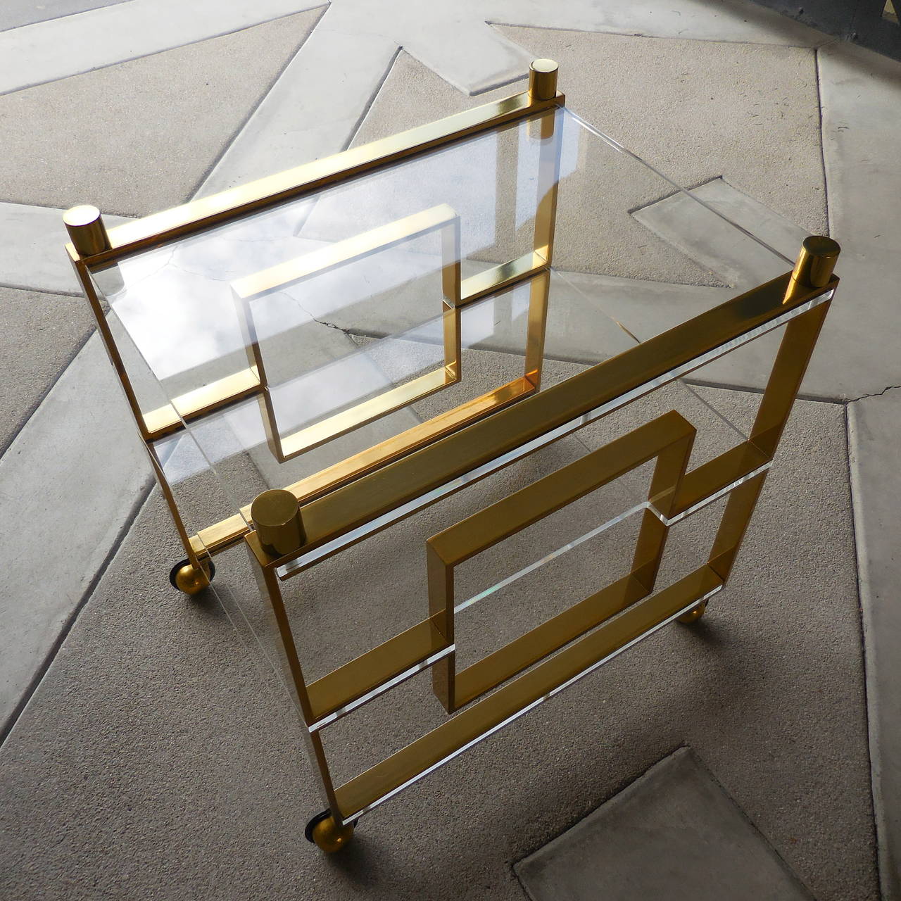 A glamorous bar or serving cart, composed of brass-plated, solid flat-bar steel and Lucite, by legendary designer Charles Hollis Jones. This cart was created specifically for Christopher Anthony Ltd and was part of the collection that Mr. Jones