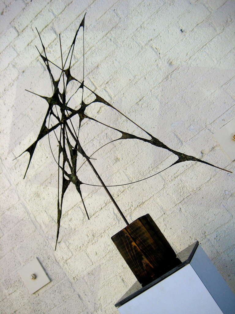 A striking abstract expressionist 1950's steel and copper sculpture on a bold wooden base with a black granite bottom.