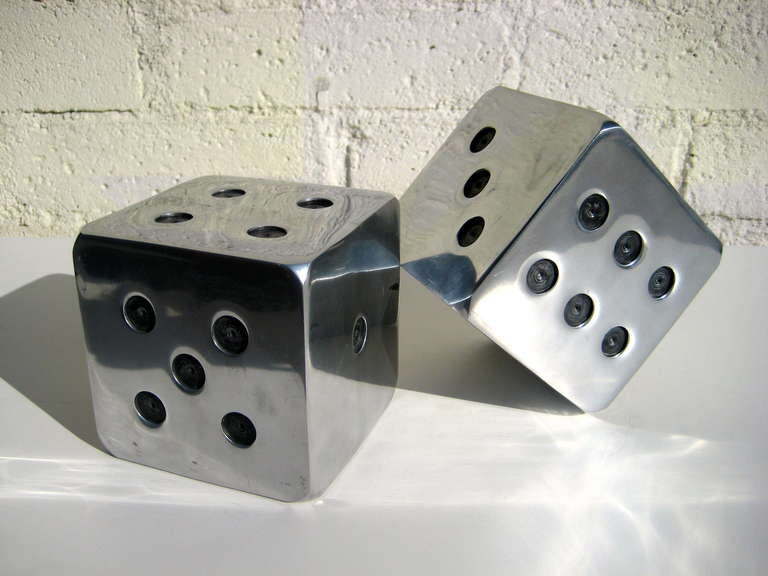 A pair of vintage 1980's oversized chrome plated bookend in the form of dice with blackened bit-drilled 