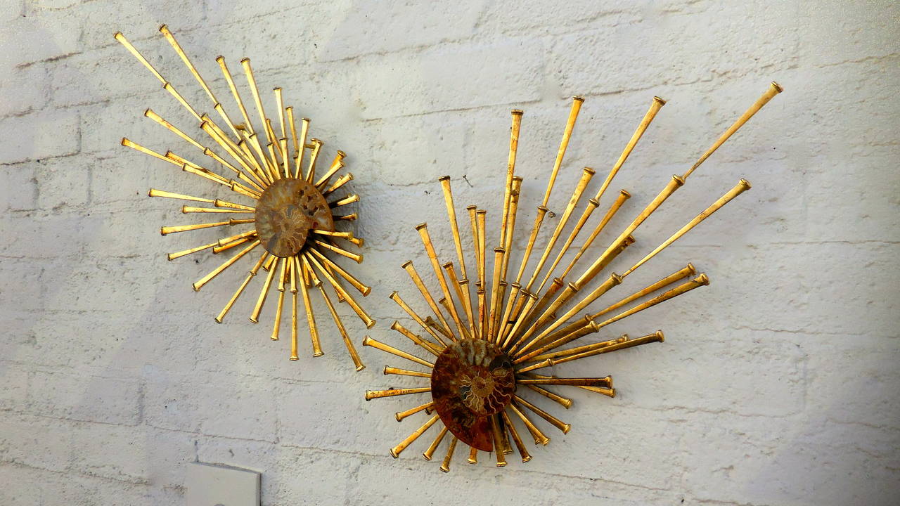 A pair of custom fabricated wall sculptures featuring fossilized chambered nautilus shells set into a Baroque inspired modernist sculptural framework.
These glittering pieces are unique and utterly beautiful.