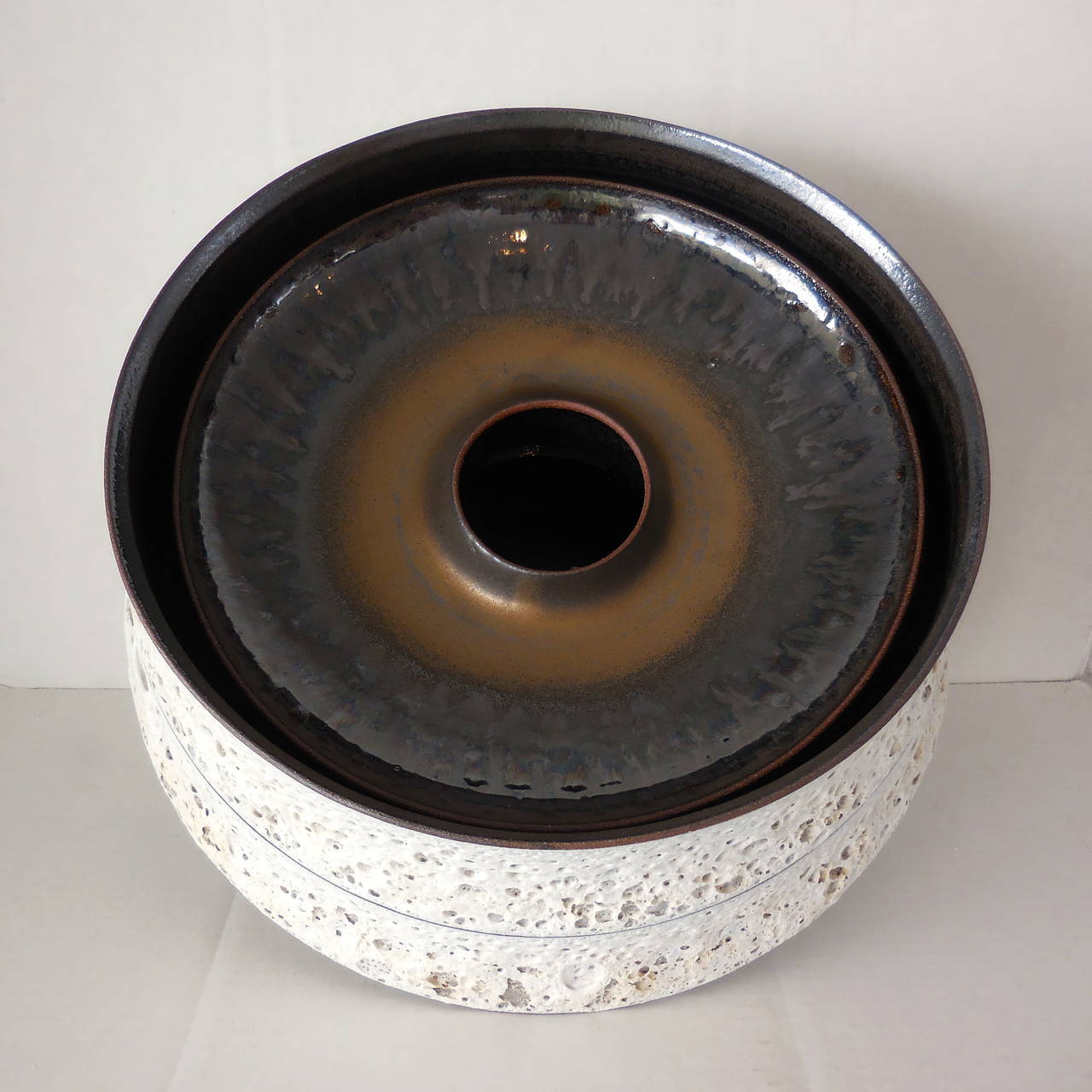 A truly spectacular, hand thrown double walled vessel by American artist Jeremy Briddell. This piece has a white 