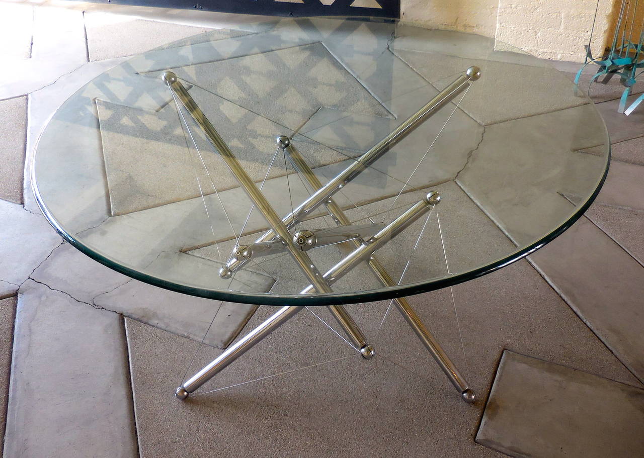 A dynamically charged #714 dining table designed by Theodore Waddell for Cassina in 1972. 
Polished chrome plated steel wit steel tension wires.
Popularly known as a 
