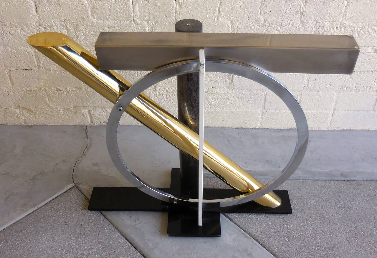 A strikingly sculptural console table deigned by Kaizo Oto for Design Institutes of America in the 1980's. Inspired by the Post Modernist subset 