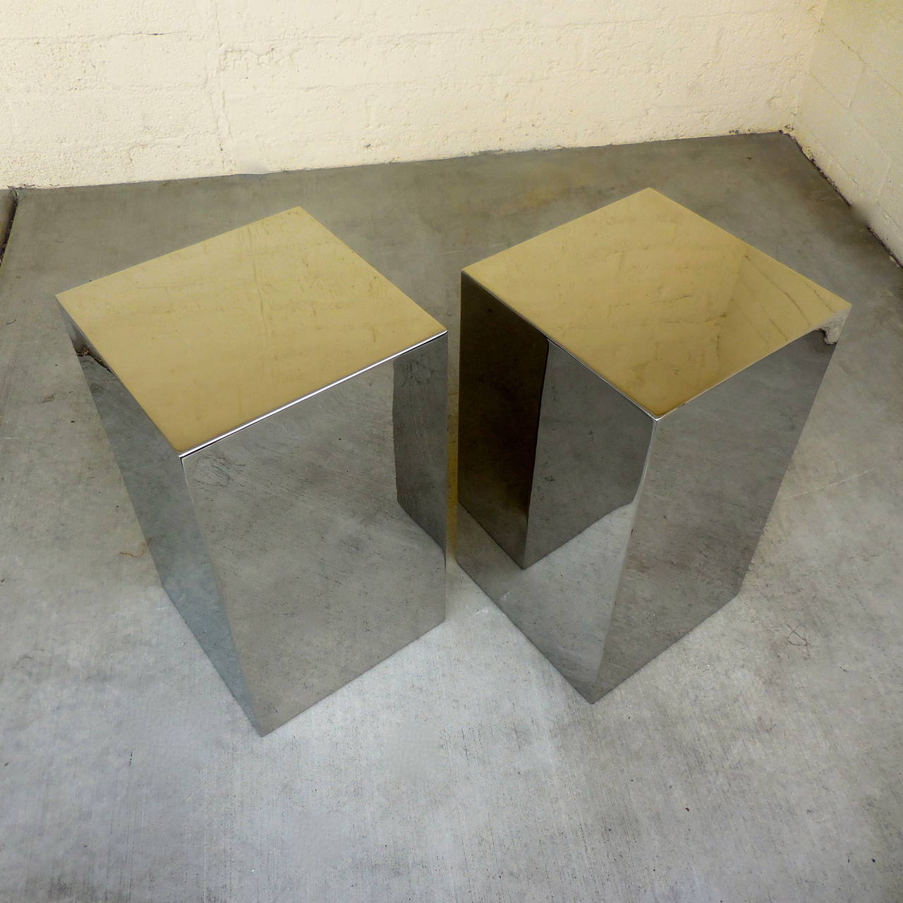 A sleek pair of stainless steel square occasional tables that have been polished to a mirror finish. They date from the 1970s and are in excellent, restored condition.