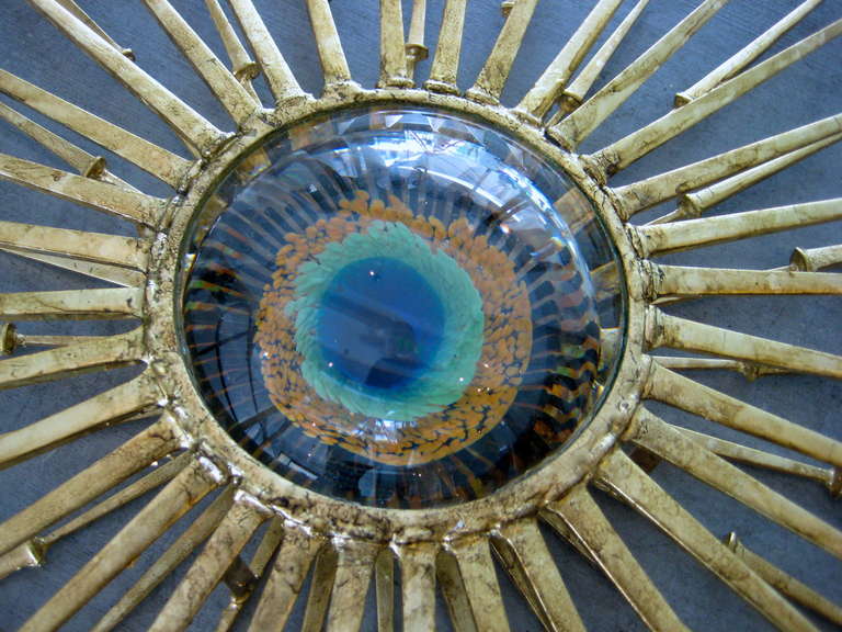 A radiant gold leafed wall sculpture with vintage Murano glass eye in