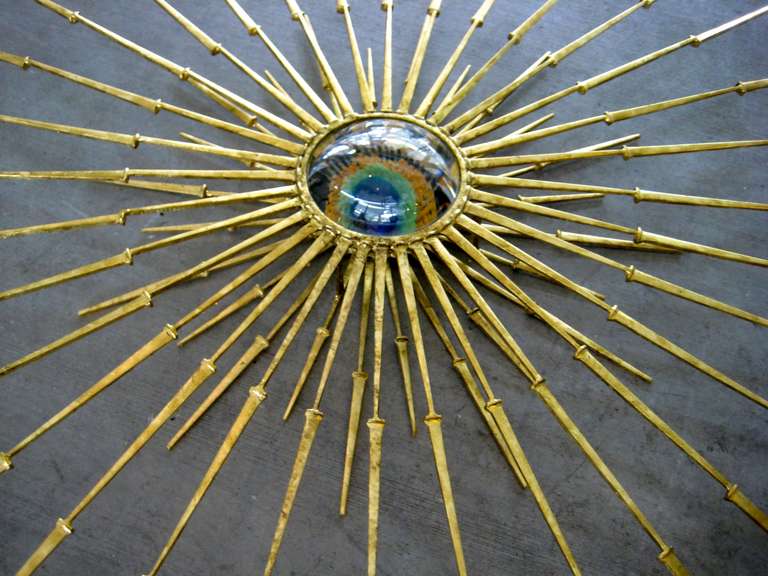 Welded A radiant gold leafed wall sculpture with vintage Murano glass eye in the center by Del Williams