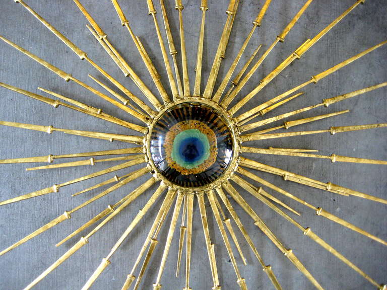 Steel A radiant gold leafed wall sculpture with vintage Murano glass eye in the center by Del Williams