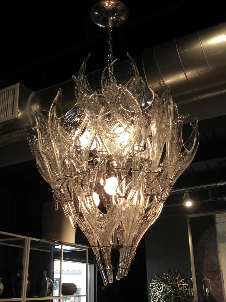 A sleek and sexy vintage Murano glass chandelier consisting of individually blown clear glass 