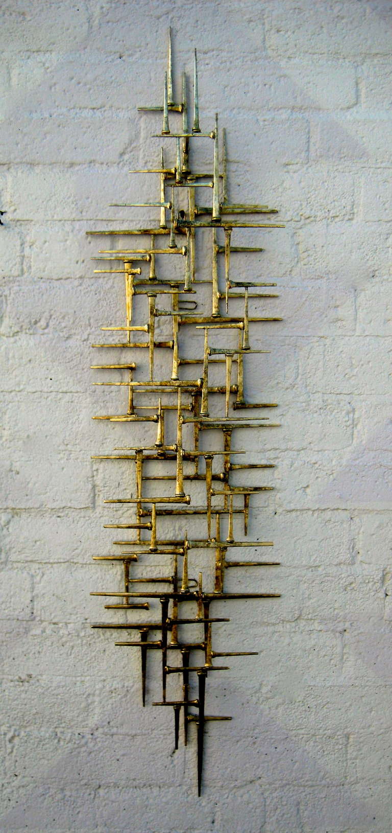 An original gilded modernist themed wall sculpture by American artist Del Williams. Dated 2014. Del hand welds and gold leafs his sculptures using traditional welding techniques.