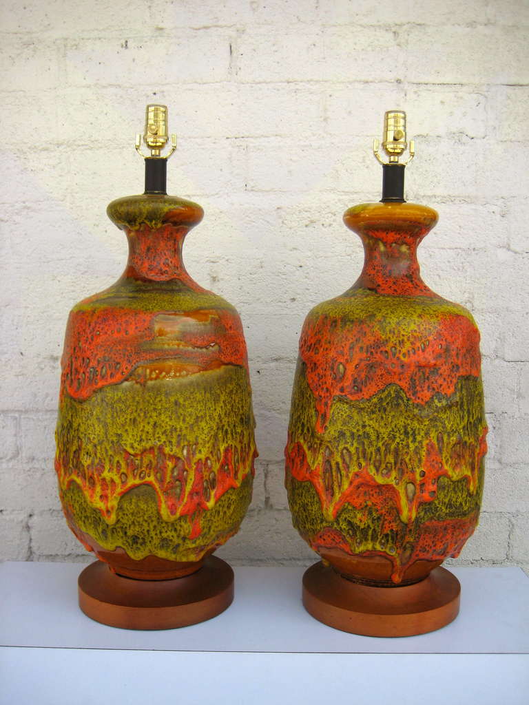 A very colorful and dynamic pair of heavily glazed orange and chartreuse table lamps. The under glaze is amber with a heavily layered over glaze that has a wonderful array of snaps, crackles and pops...all the desired result of firing with this type
