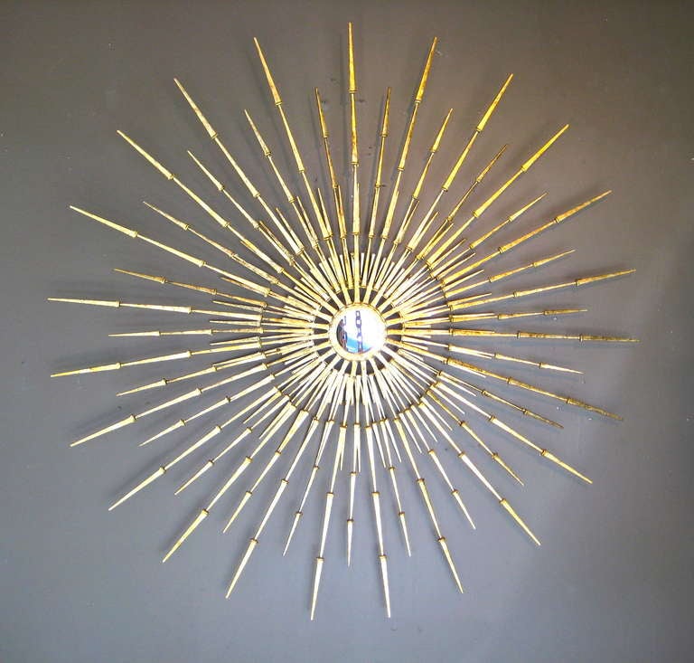 A gilded steel starburst wall sculpture by American artist Del Williams. This 51