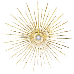 A large 51" diameter starburst wall sculpture by American sculptor Del Williams