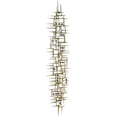 A  74" long gilded steel wall sculpture by American artist Del Williams
