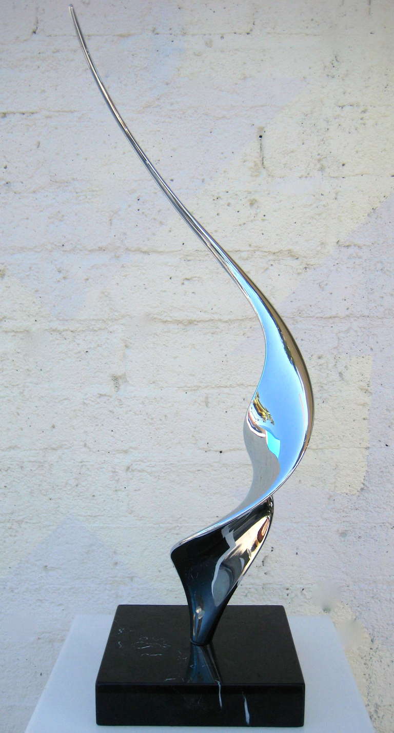 A dynamically soaring polished chrome plated steel sculpture by American artist Lou Pearson (1925-2005). Signed and inscribed L.Pearson 76-CP-1.
Original black marble base.