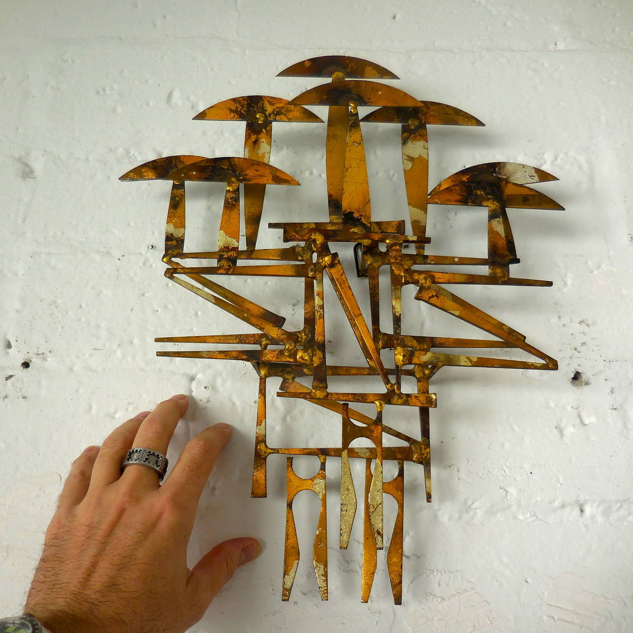 A diminutive gilded wall sculpture depicting stylized mushrooms by American artist William Bowie, circa 1960.