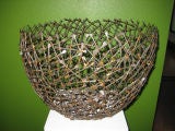 A Contemporary hand made basket formed from welded nails A Contemporary hand made basket formed from welded nails
