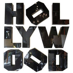 A vintage "Hollywood" sign in all black letters