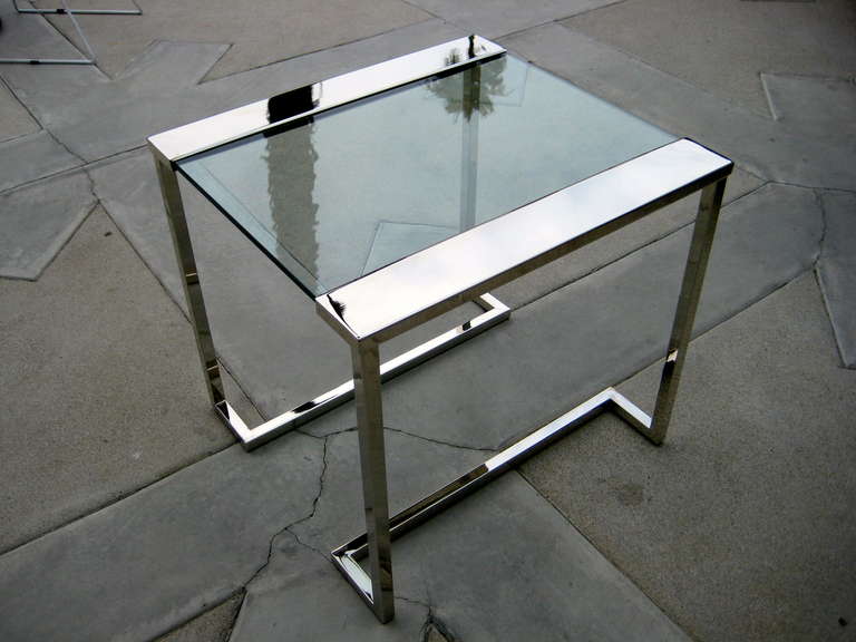 A striking nickel plated and glass side table in the style of Pace Collection c.1970's. Newly replated in nickel and new glass has been cut for the top.