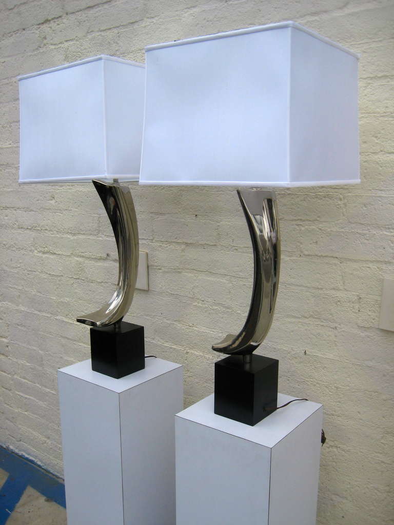 A striking pair of chrome plated steel sculptural table lamps in the form of 