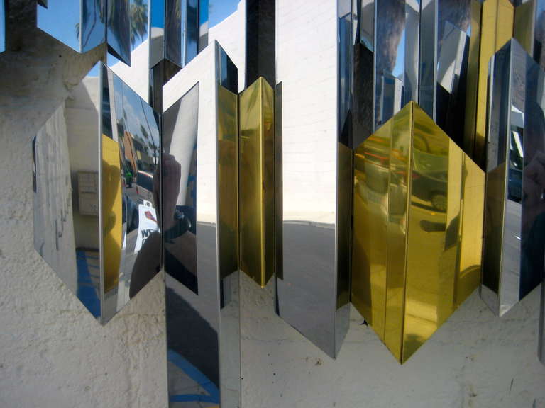Stainless Steel A sparkling chrome and brass cityscape wall sculpture by C. Jere. C.1970's.