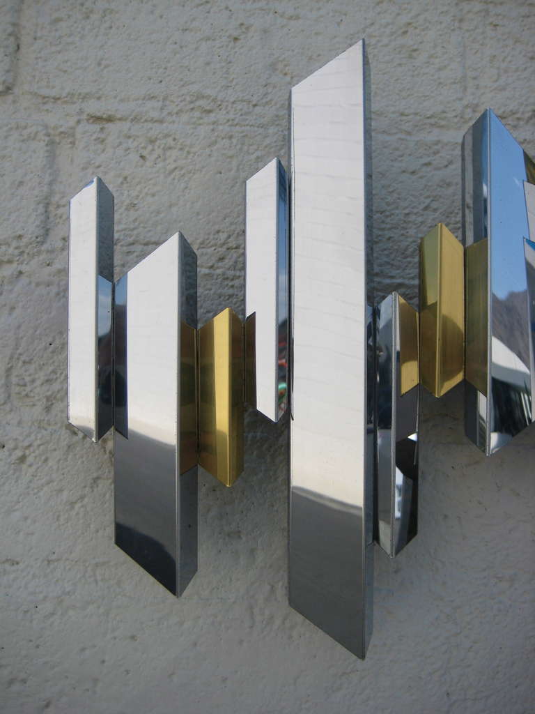 A sparkling chrome and brass cityscape wall sculpture by C. Jere. C.1970's. 1