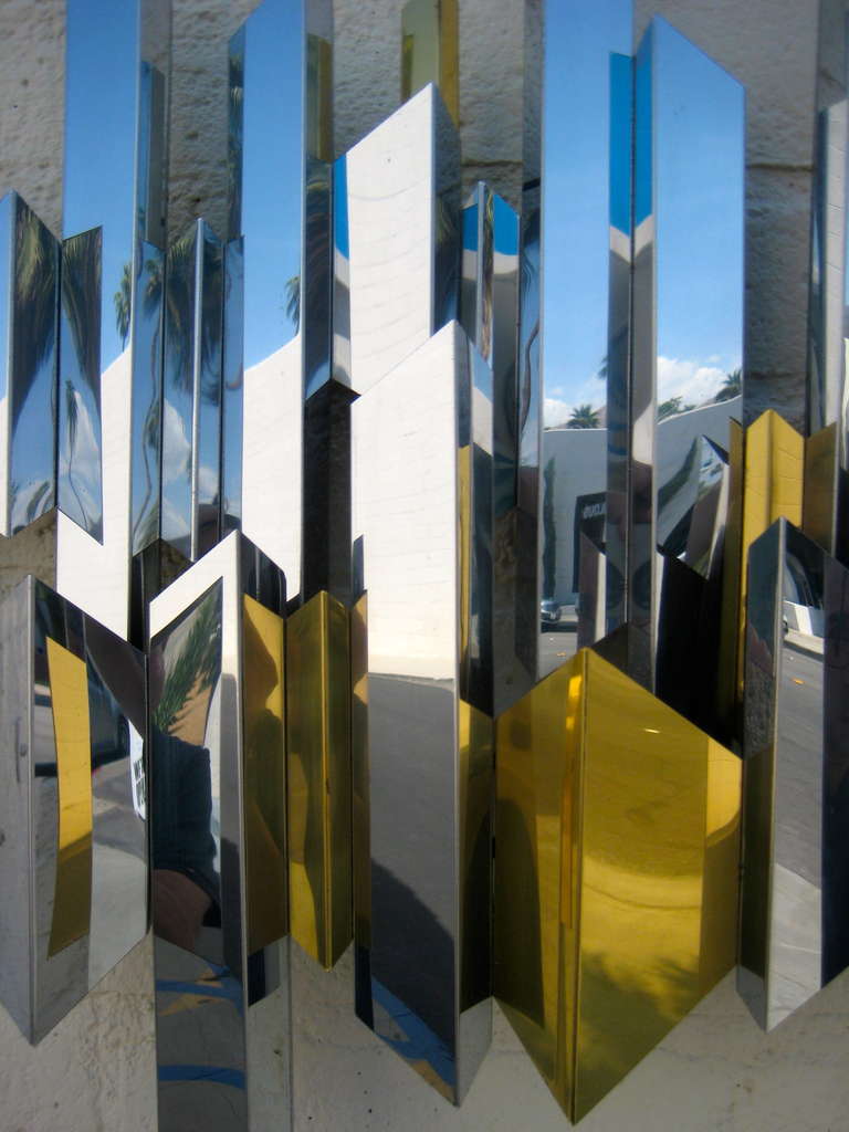 A sparkling chrome and brass cityscape wall sculpture by C. Jere. C.1970's. 2
