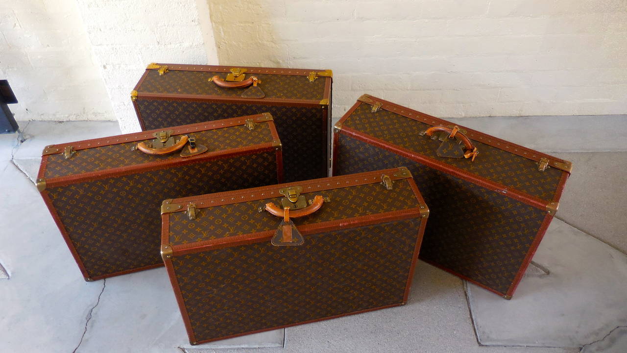 An amazing grouping of four pieces of vintage 1970s Louis Vuitton hard-sided luggage. These pieces are from the renowned Alzer series and sport the LV monogram. As Vuitton says themselves, these pieces are 