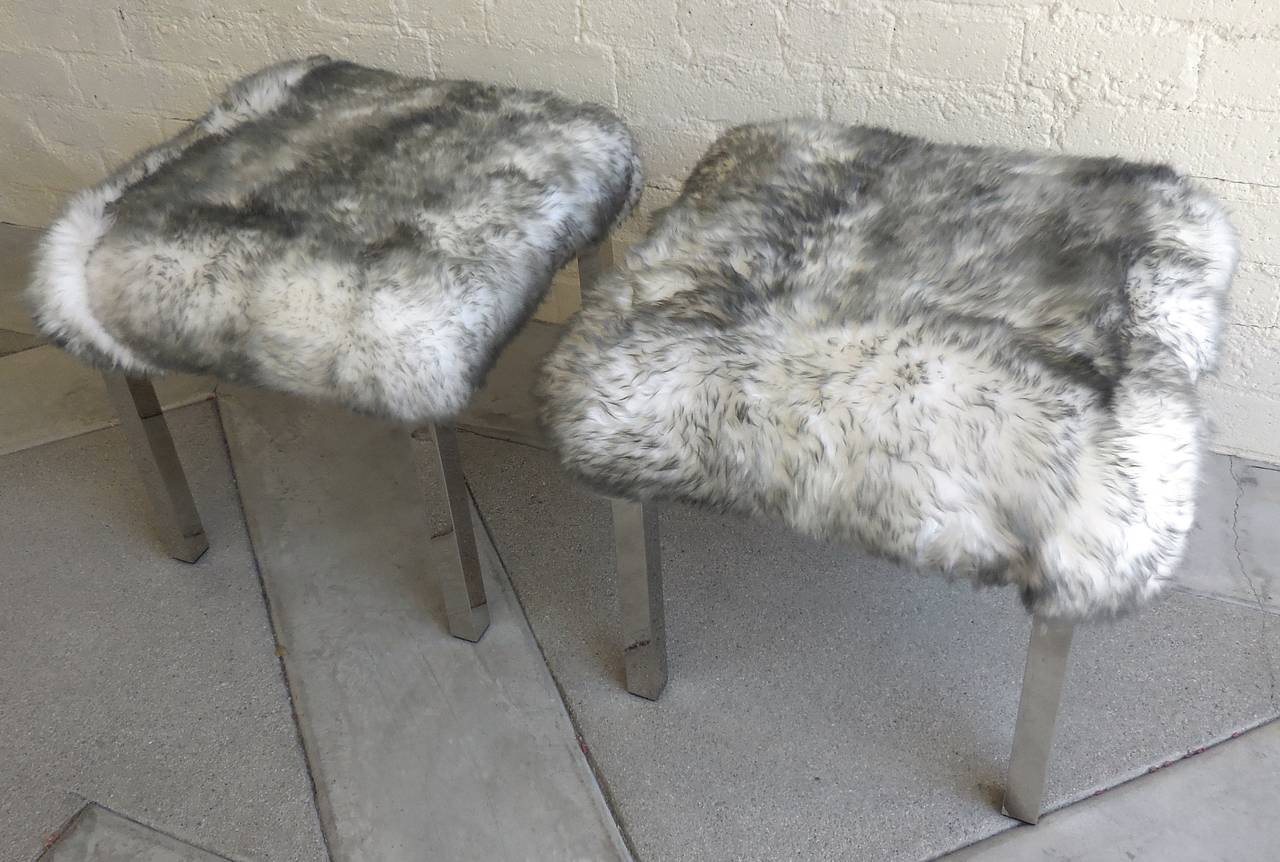A pair of voluptuous tipped sheepskin upholstered benches. The Parsons style bases are straightforward chrome-plated steel. These bases combined with the decadent tops make for a delightful pair. Perfect for an over the top closet or at the end of a