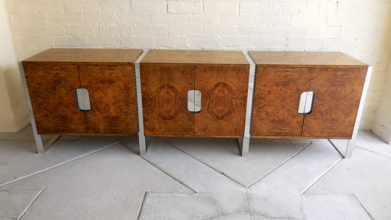 A very high quality three section burled walnut credenza from the 1970s, with the design attributed to Milo Baughman. Each of the three distinct cabinet sections is flanked by a chrome-plated steel framework, with the end pieces having the addition