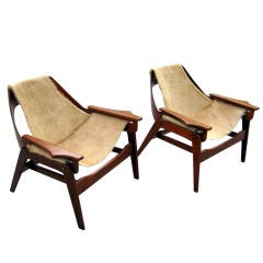 A pair of walnut sling chairs designed by Jerry Johnson in 1964